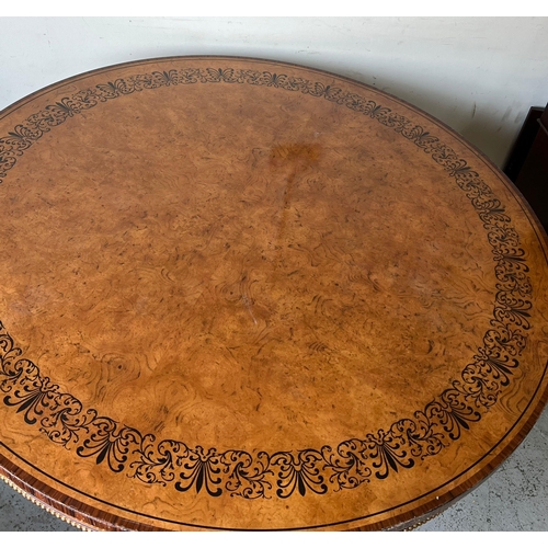 75 - A Regency style centre table, three ornate scrolling legs on a concave platform base with carved scr... 