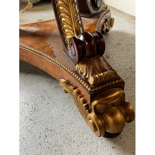 75 - A Regency style centre table, three ornate scrolling legs on a concave platform base with carved scr... 