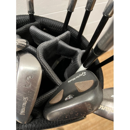 751 - A set of golf clubs with accessories, various cubs and markers including Odyssey, Callaway Big Berth... 