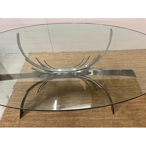 80 - A contemporary glass dining table on brushed chrome sculptural legs (210cm x 128cm x 75cm)