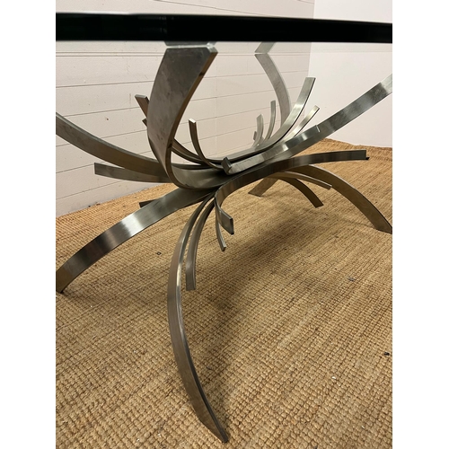 80 - A contemporary glass dining table on brushed chrome sculptural legs (210cm x 128cm x 75cm)