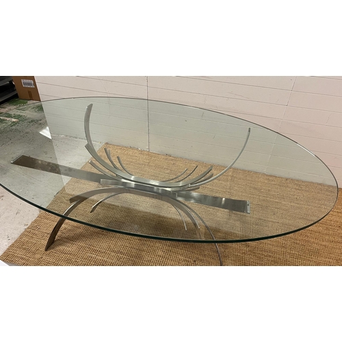 80 - A contemporary glass dining table on brushed chrome sculptural legs (210cm x 128cm x 75cm)