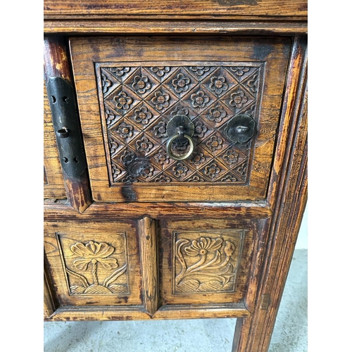 85 - A vintage Burmese two drawer wine table with carved floral detail (H85cm W108cm D55cm)