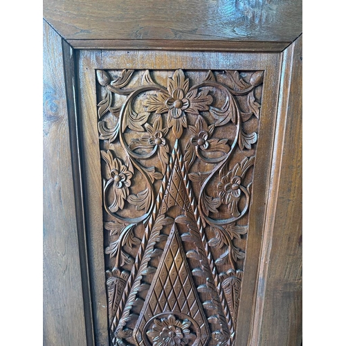 92 - A hand carved vintage oak two door cupboard on raised feet with two inner shelves AF (H166cm D40cm W... 