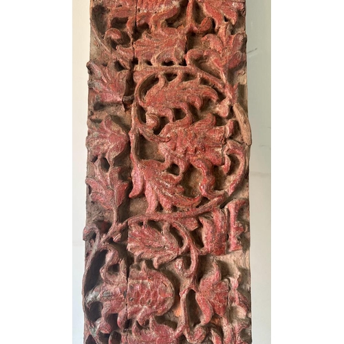 93 - A Burmese hand carved wall hanging oak panel with red painted floral relief 234cm x 18cm