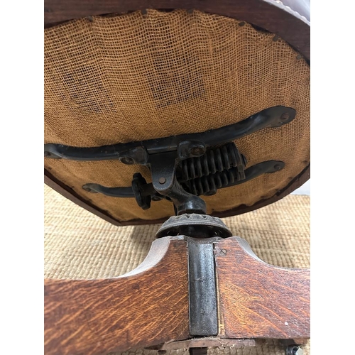 95 - An late Victorian oak framed Captain chair upholstered in burgundy leather