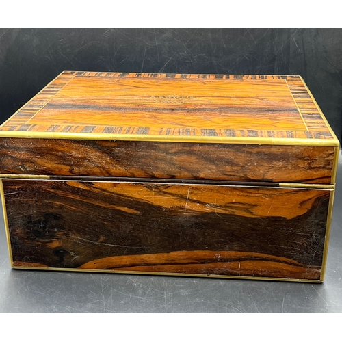 524A - A Victorian coromandel travelling toilet case/box with brass edges and campaign handles with inlaid ... 