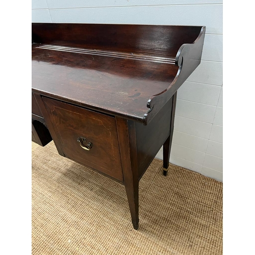 209 - A mahogany sideboard or serving table with cellarette drawer (H103cm W135cm D59cm)