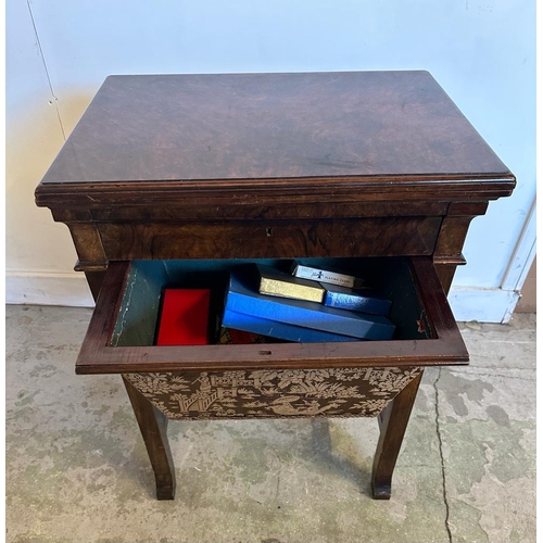 103 - A burr walnut games table with swivel top, green baize and chess board (H77cm W58cm D42cm)