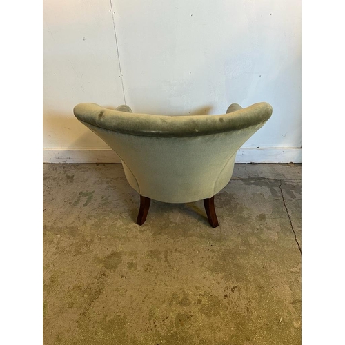 108 - A Mid Century button back arm chair upholstered in green