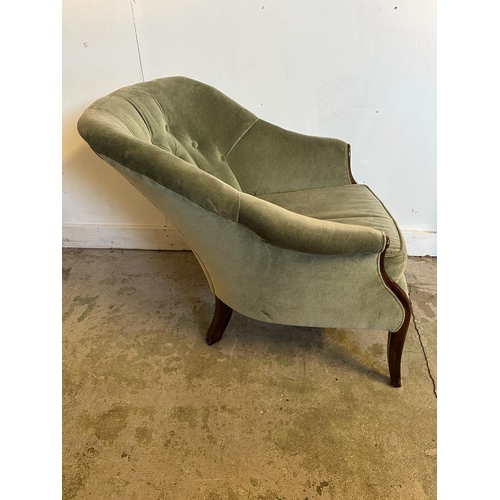 108 - A Mid Century button back arm chair upholstered in green