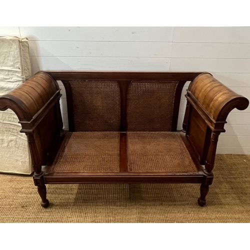 114 - A colonial style caned and carved settee/bergère (H89cm W150 D60cm)