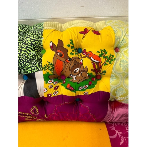 118 - A Disney themed patch work Chesterfield style button backed two seater sofa (H78cm W200cm D90cm SH40... 