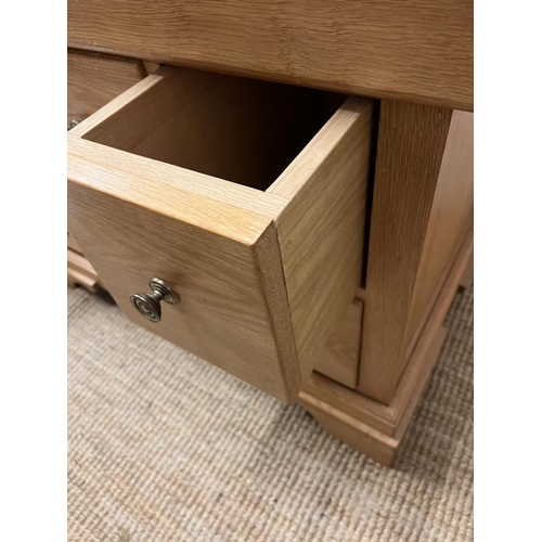 12 - A light oak chest of drawers (H79cm W101cm D63cm)