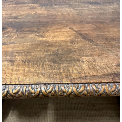 139 - An oak Italian renaissence style hall table with peg end cross streacher and lions paw feet