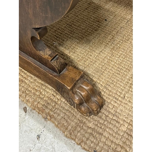 139 - An oak Italian renaissence style hall table with peg end cross streacher and lions paw feet