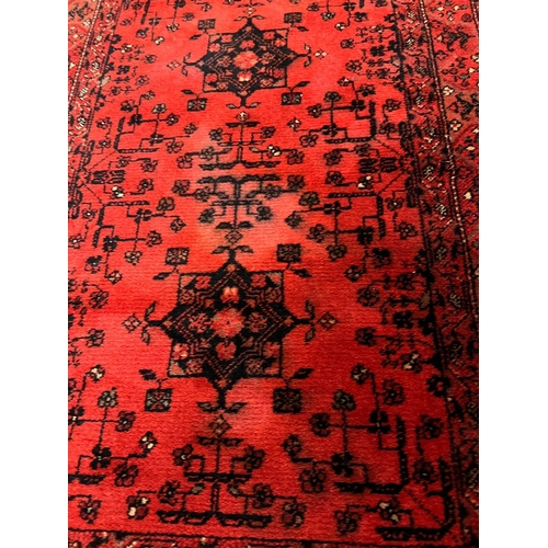 152 - A red ground runner rug 270cm x 69cm