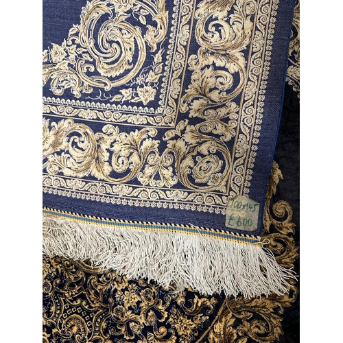 153 - A silk rug with blue grounds and gold scrolling border and central scrolling medallion 148x100