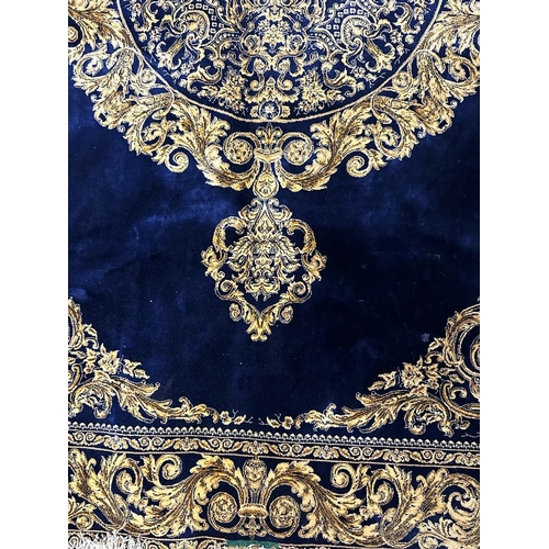 153 - A silk rug with blue grounds and gold scrolling border and central scrolling medallion 148x100