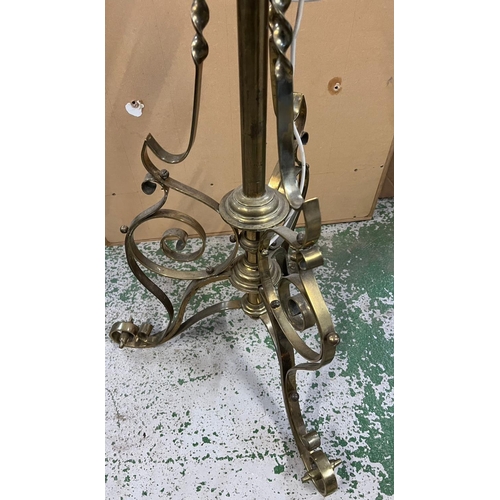 175 - A brass floor standing lamp with scrolling detail