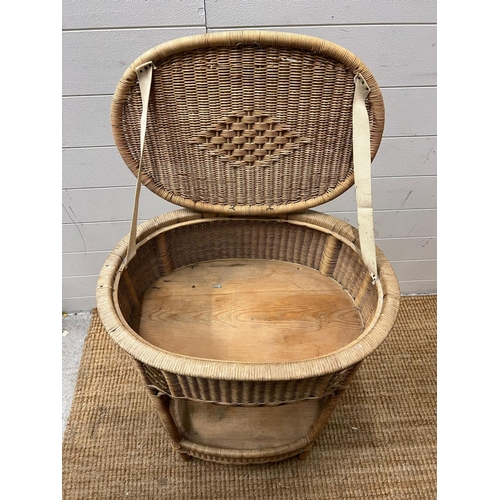 18 - An oval wicker side table (H75cm W54cm D35cm)