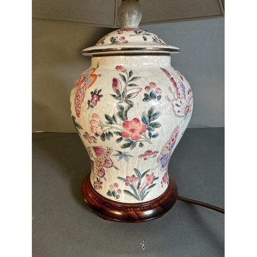 180 - A ceramic painted table lamp with flower and butterfly detail