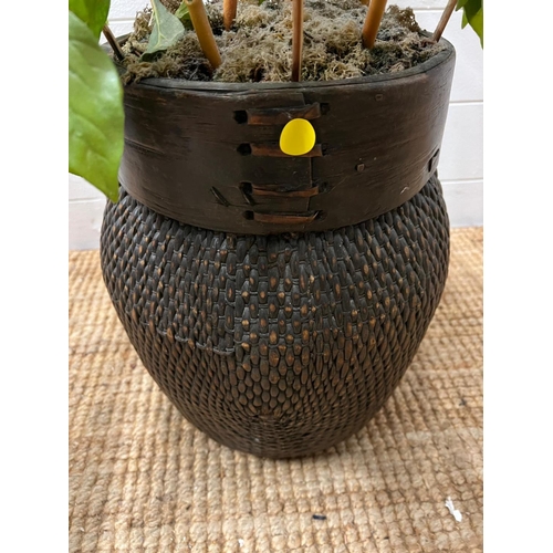 198 - A faux plant in a wicker pot