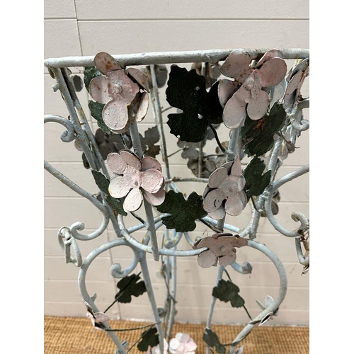 199 - A wrought iron plant stand with leaf and flower detail painted in pinks and green (H103cm)