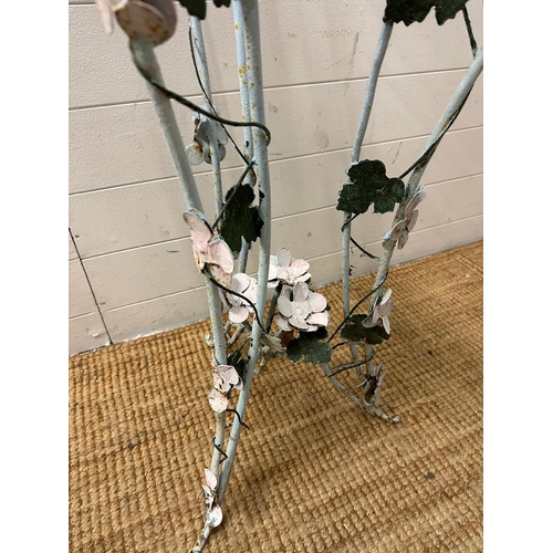 199 - A wrought iron plant stand with leaf and flower detail painted in pinks and green (H103cm)