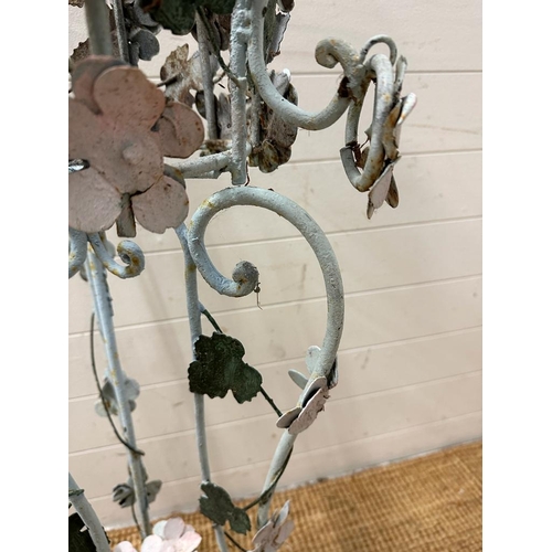 199 - A wrought iron plant stand with leaf and flower detail painted in pinks and green (H103cm)