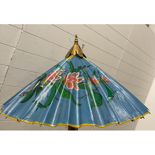 200 - A vintage Chinese parasol, blue grounds with floral details