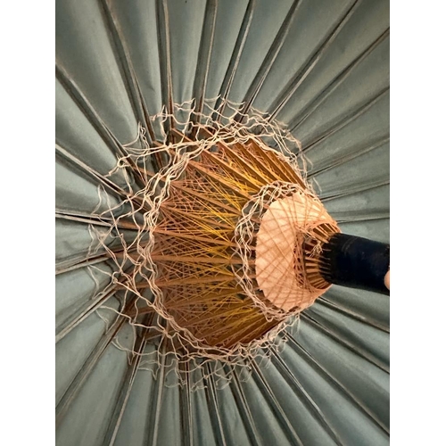 200 - A vintage Chinese parasol, blue grounds with floral details