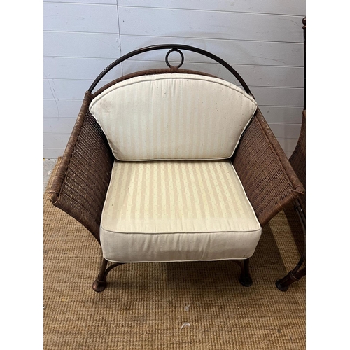 204 - A metal rattan rustic garden suite comprising of a two seater sofa, his and her chairs, footstool an... 