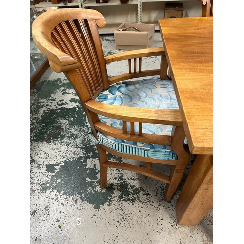 23 - An oak dining table with four chairs and two carvers