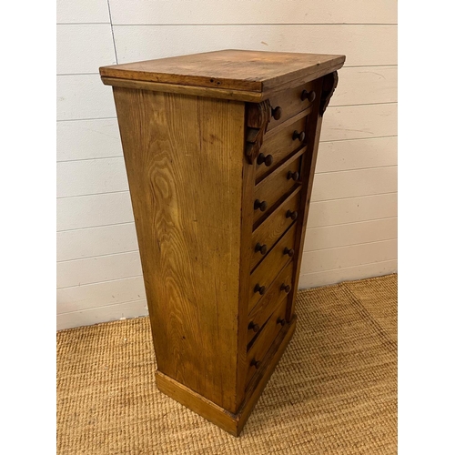 24 - A light oak Wellington chest with graduating drawers (H104cm W51cm D36cm)