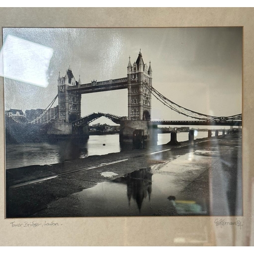 302 - Two black and white framed photographs of London, Tower Bridge and St Pauls both signed lower right ... 