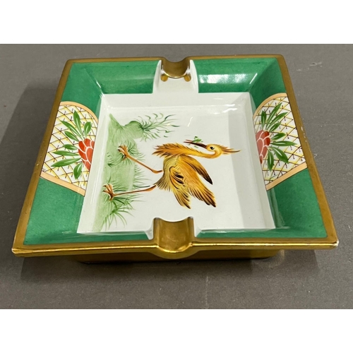 323 - A Hermes porcelain tray with an exotic bird to centre (18.5cm x 15.5cm)