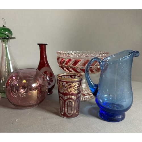 337 - A selection of coloured glass to include vases, jugs and dishes