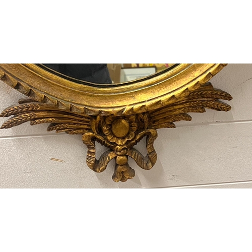 384 - A neoclassical style oval giltwood mirror (H120cm W64cm)