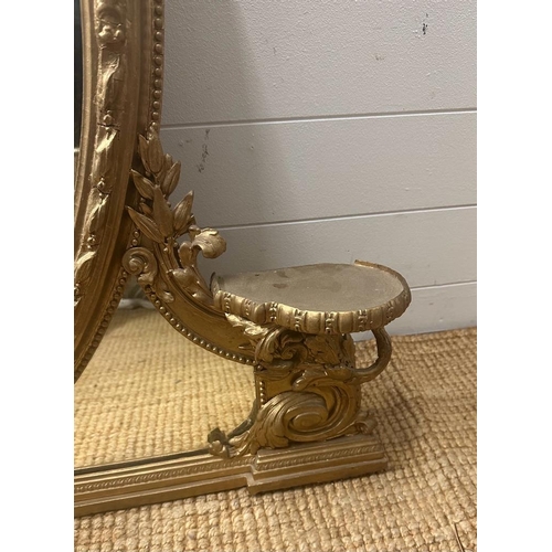 385 - A large gilt framed oval over mantel mirror in Coco style AF (H117cm W121cm)