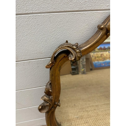 392 - A gilt framed over mantle mirror  in the rococo style. Height 75x180