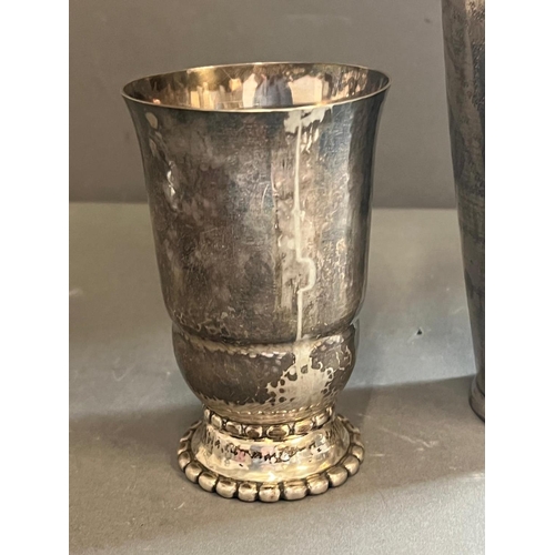 403 - A white metal hammered beaker and one hammered continental silver footed beaker (H13.5cm Weight 230g... 