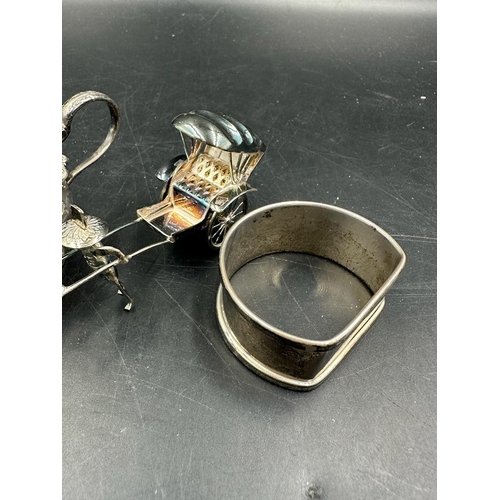 427 - A  hallmarked silver napkin ring and cruet along with a sterling silver rickshaw.