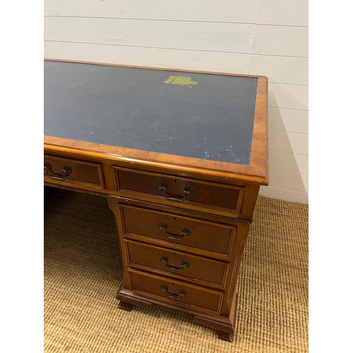 46 - A Pedestal desk with leather top on bracket feet