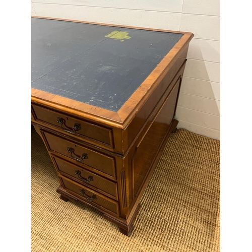 46 - A Pedestal desk with leather top on bracket feet