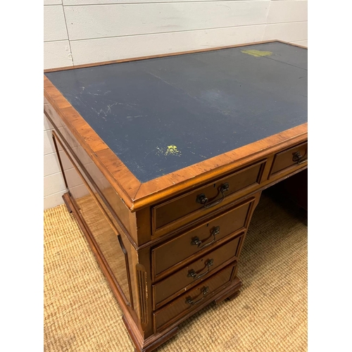 46 - A Pedestal desk with leather top on bracket feet