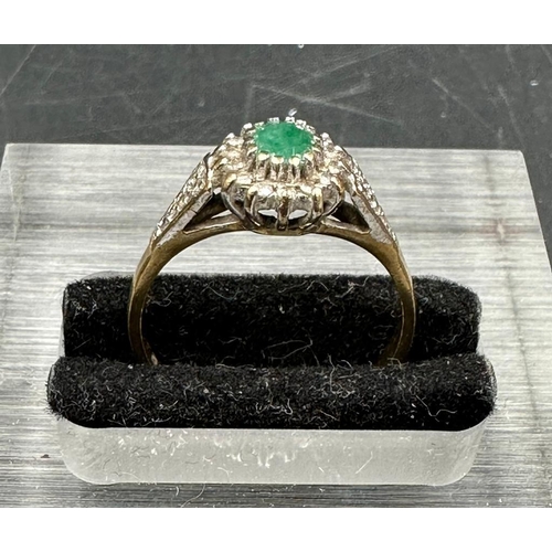 462 - A 9ct gold ring with central emerald. Approximate Total weight 2.1g size N