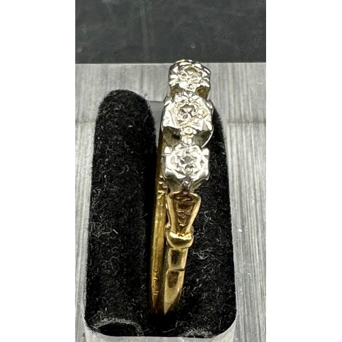 463 - An 18ct gold and platinum three stone diamond ring. Approximate total weight 2.4g Size T 1/2