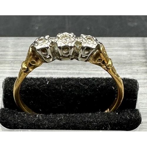 463 - An 18ct gold and platinum three stone diamond ring. Approximate total weight 2.4g Size T 1/2