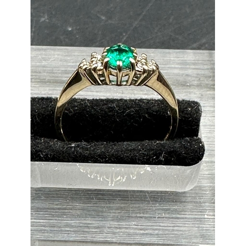 471 - A 9ct gold ring with emerald and diamonds size M